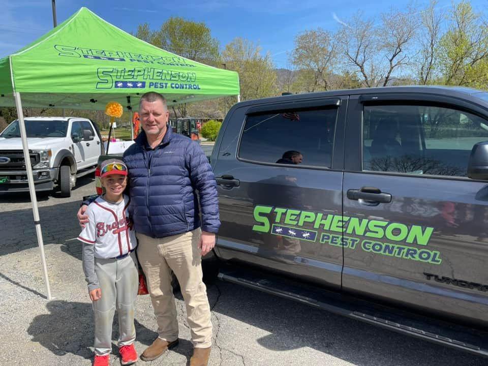 Stephenson Pest Control technician beside a company truck