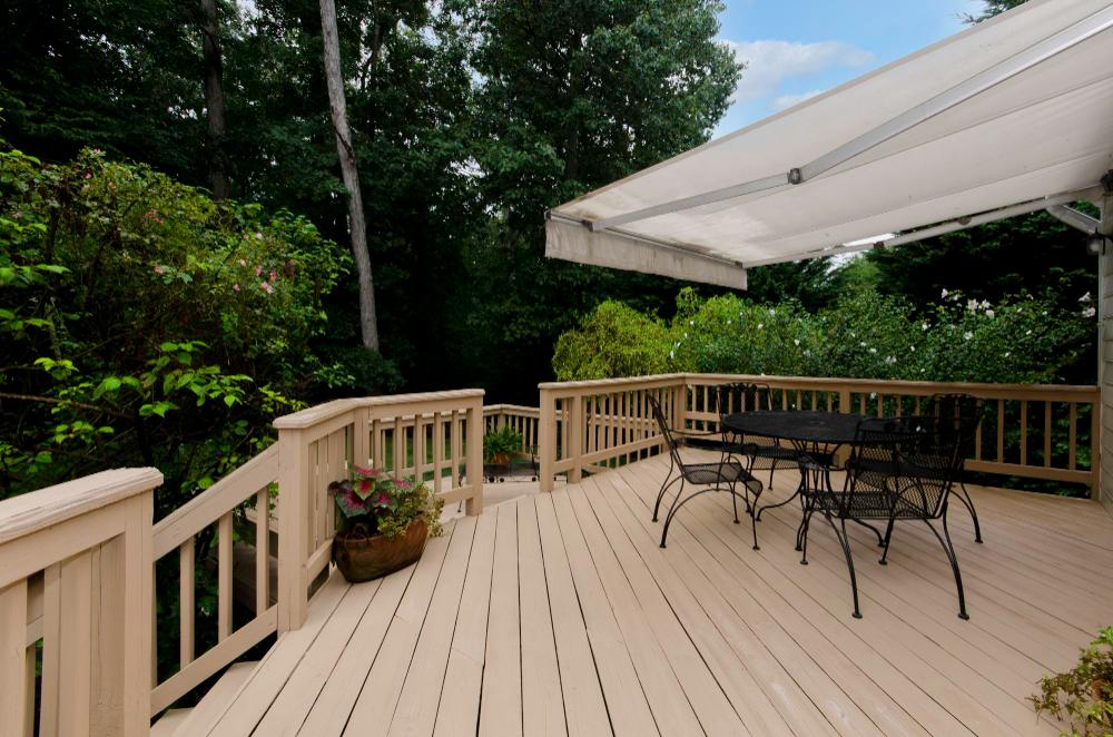 Stephenson Pest Control technician treating a deck for carpenter bees