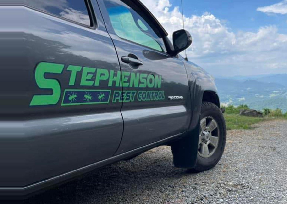 Stephenson Pest Control technician beside a company truck